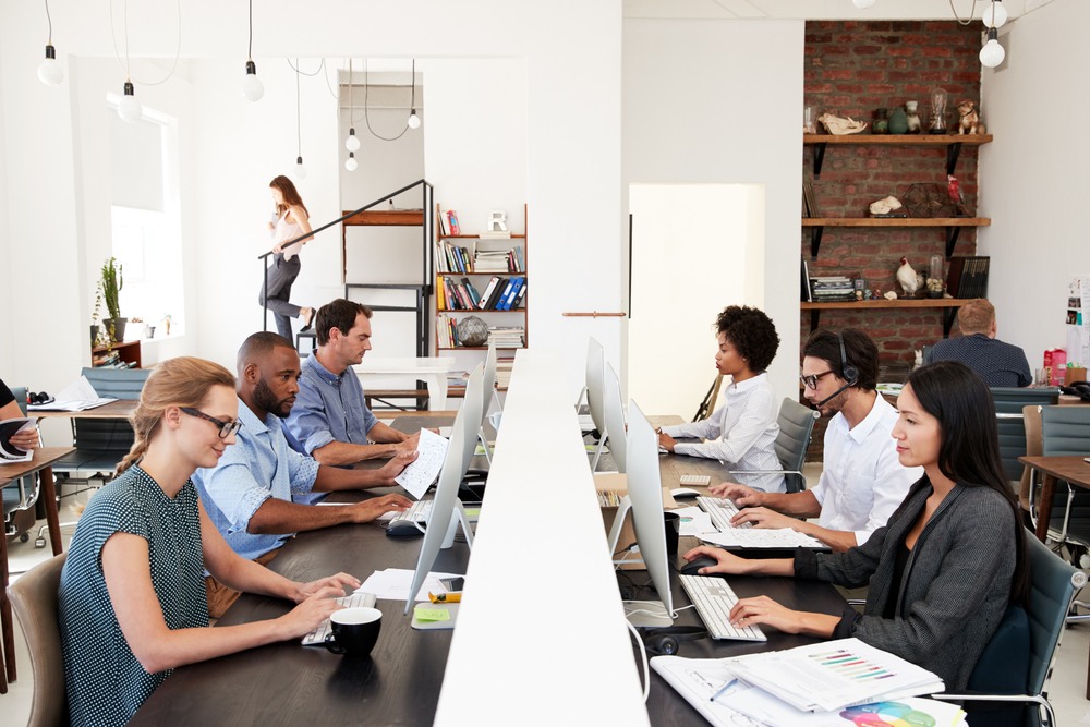 TailoredPay employees working together in the office.